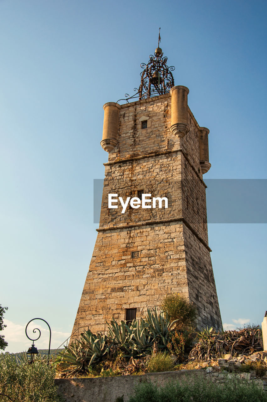 View of the clock tower made of stone at draguignan, in the french provence.