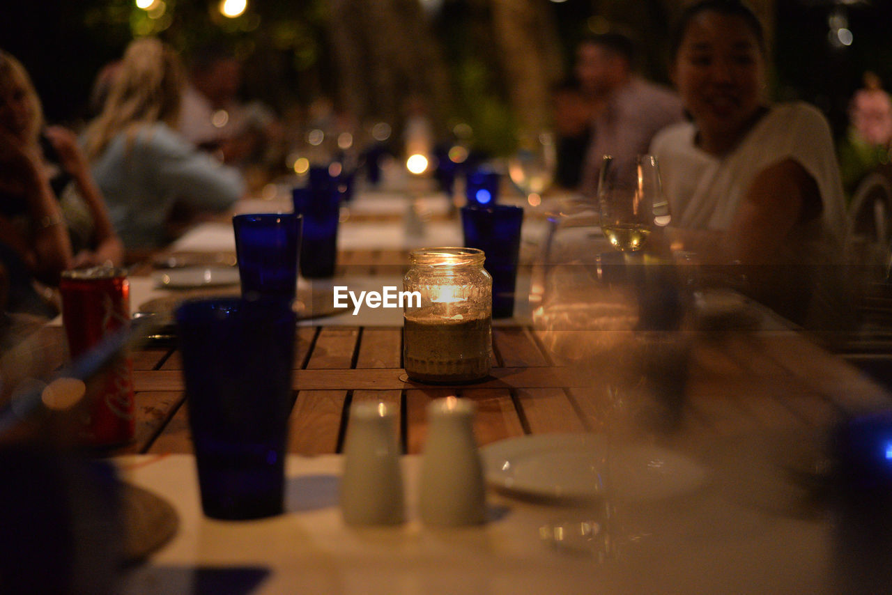 Glasses and candle on table at restaurant