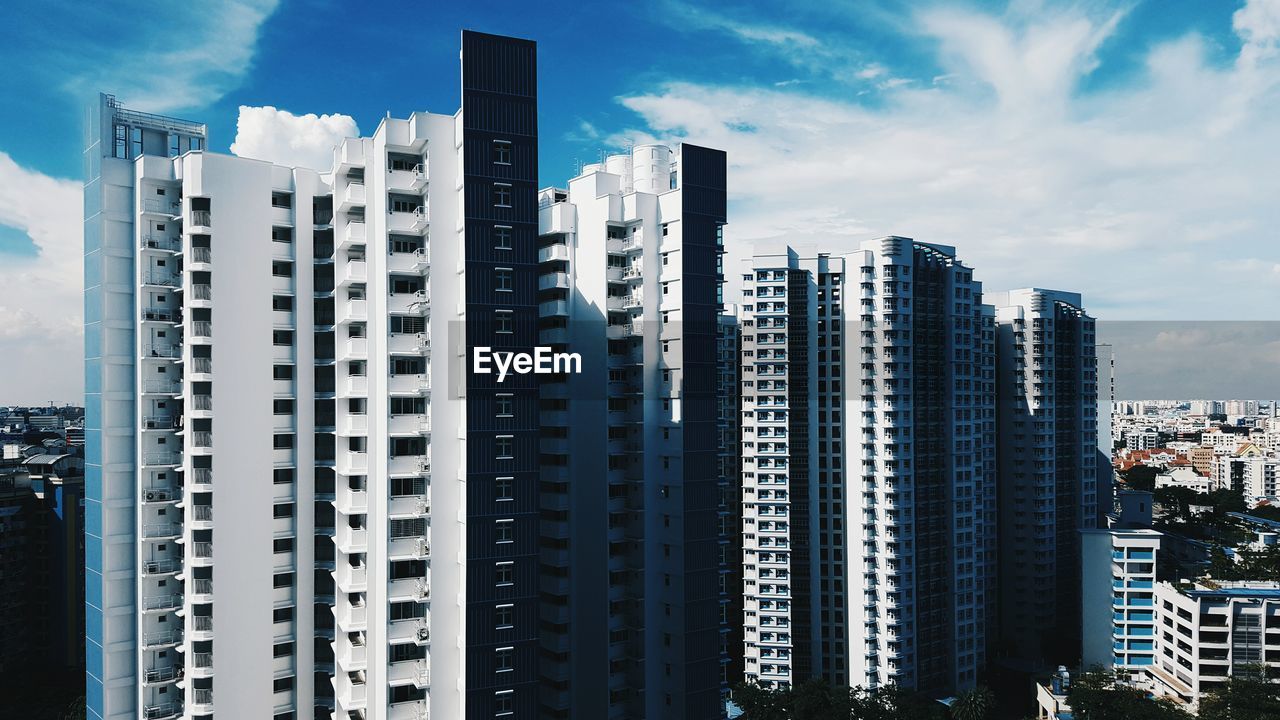 View of skyscrapers against cloudy sky