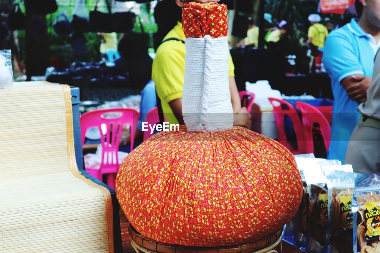 REAR VIEW OF PEOPLE ON MARKET STALL