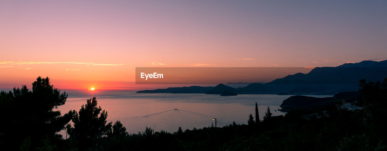 Panoramic view of sea against sky during sunset