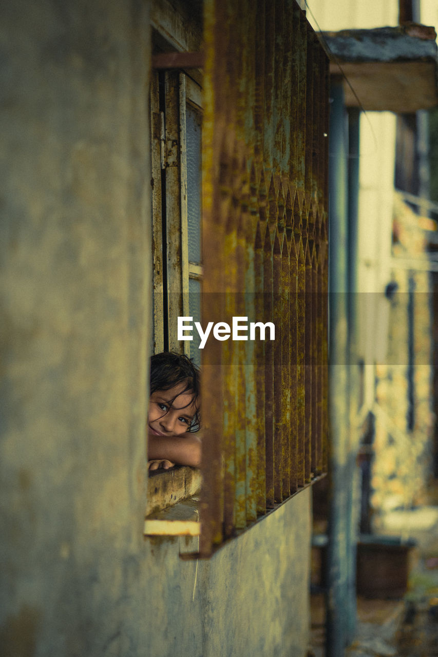 Girl looking through a window