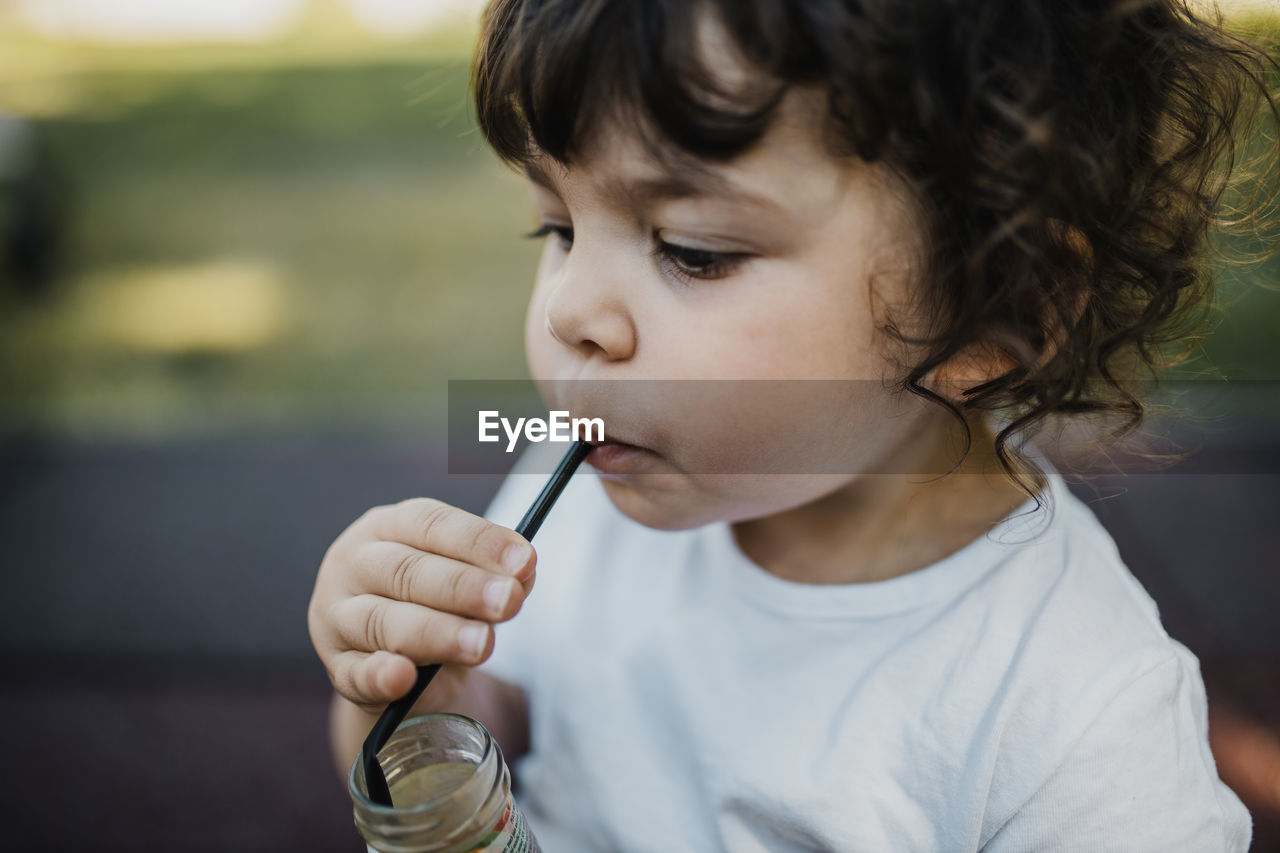 Close-up of girl drinking water