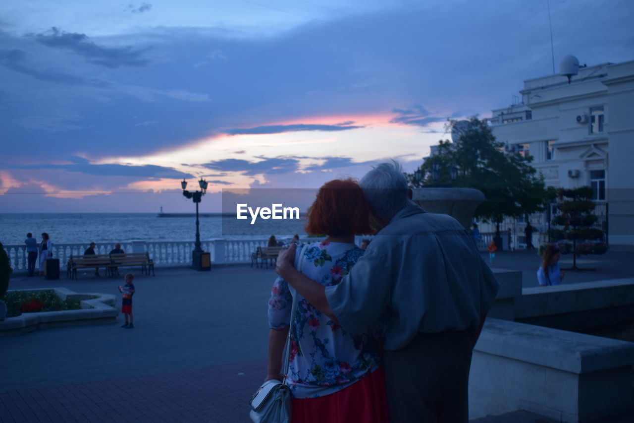 Rear view of couple looking at view of sunset