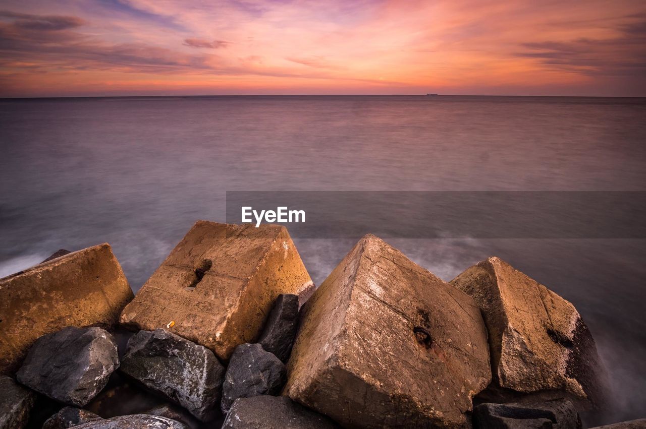 Scenic view of sea against sky at sunset