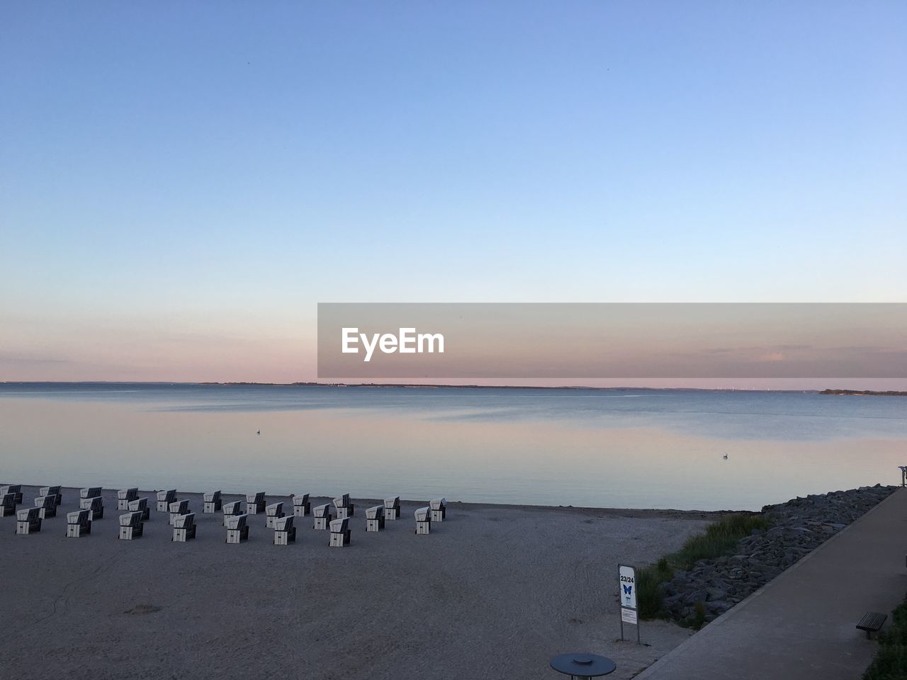 SCENIC VIEW OF BEACH AGAINST CLEAR SKY DURING SUNSET