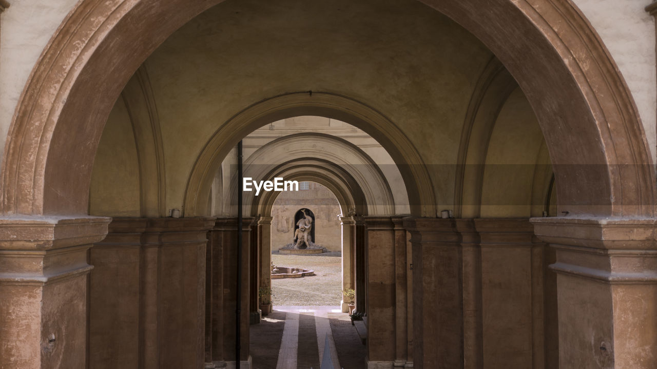 Fron view of corridor of building with archs