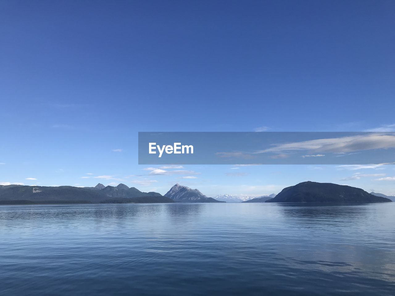 Scenic view of sea against blue sky