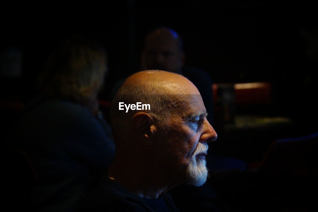 Close-up of senior man in darkroom