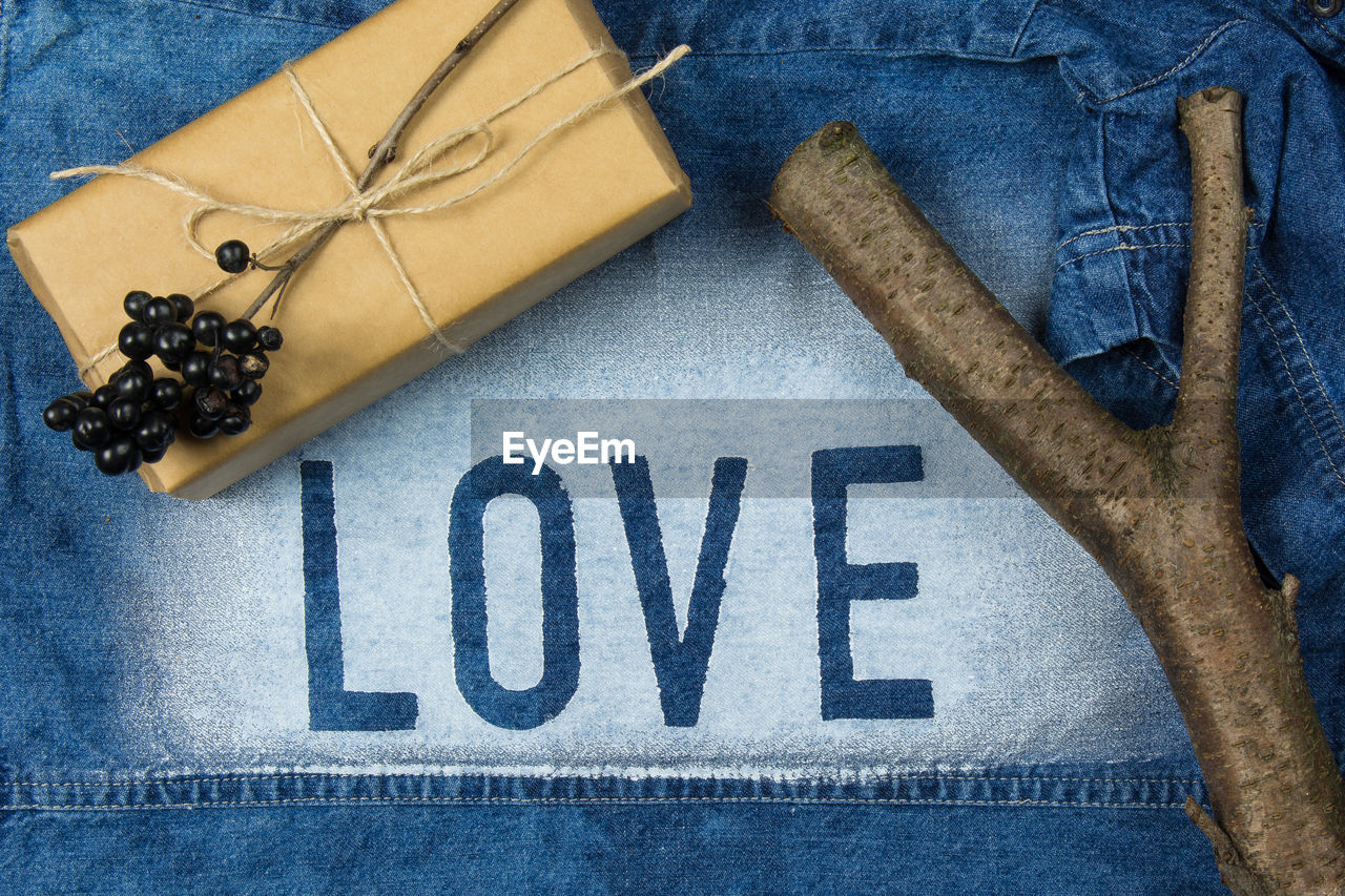 Close-up of love word written on denim