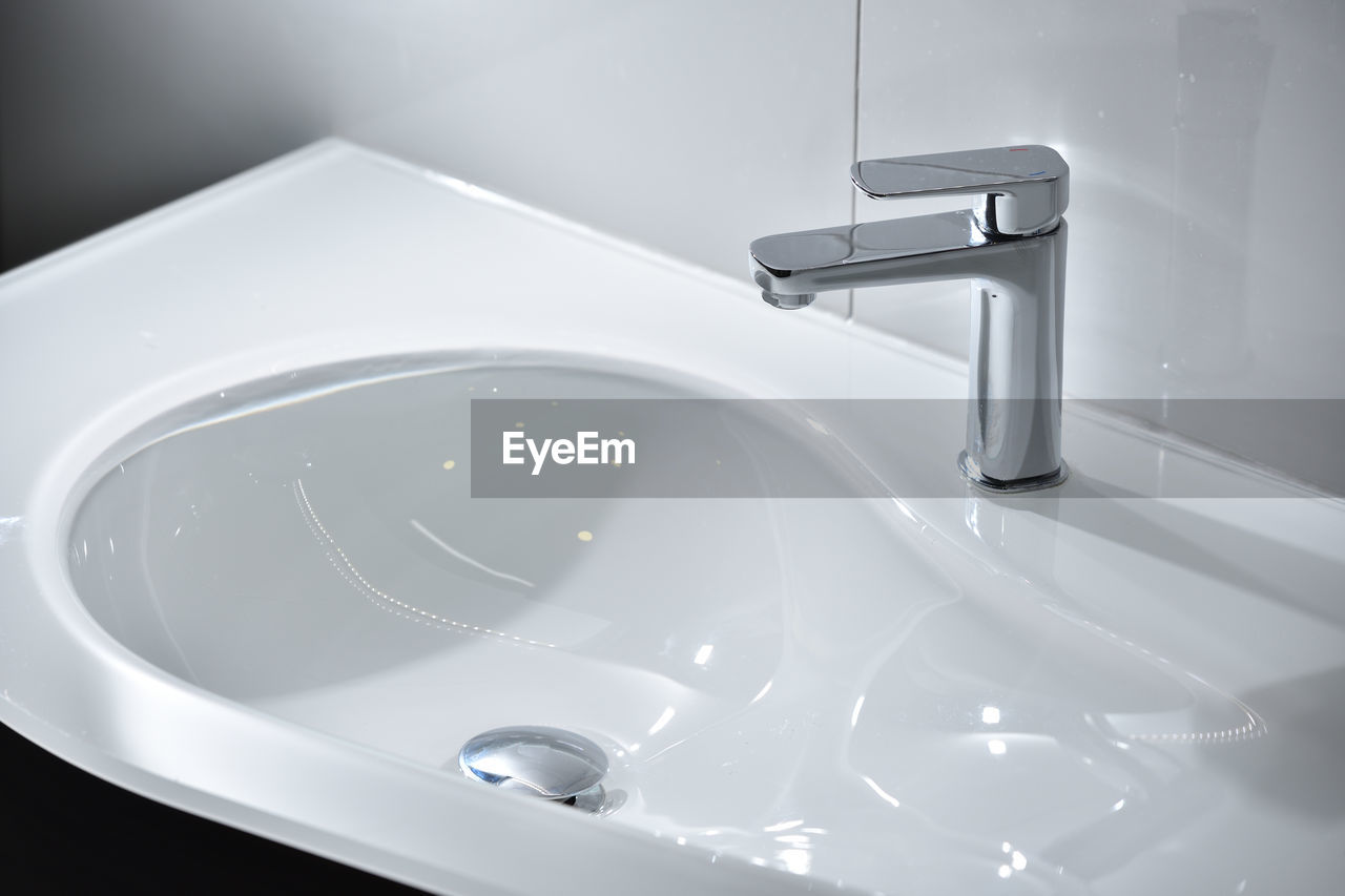 Chrome tap and white modern sink