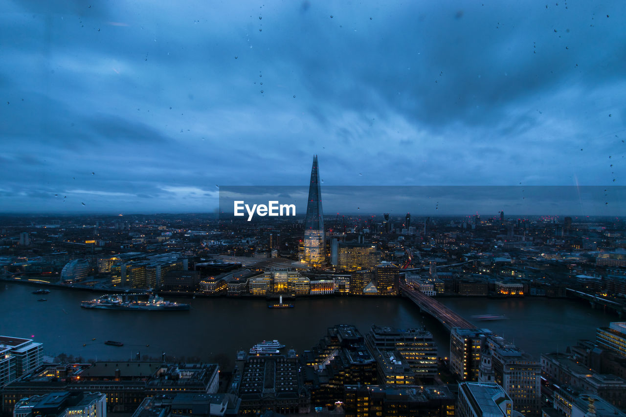 High angle view of city lit up at dusk