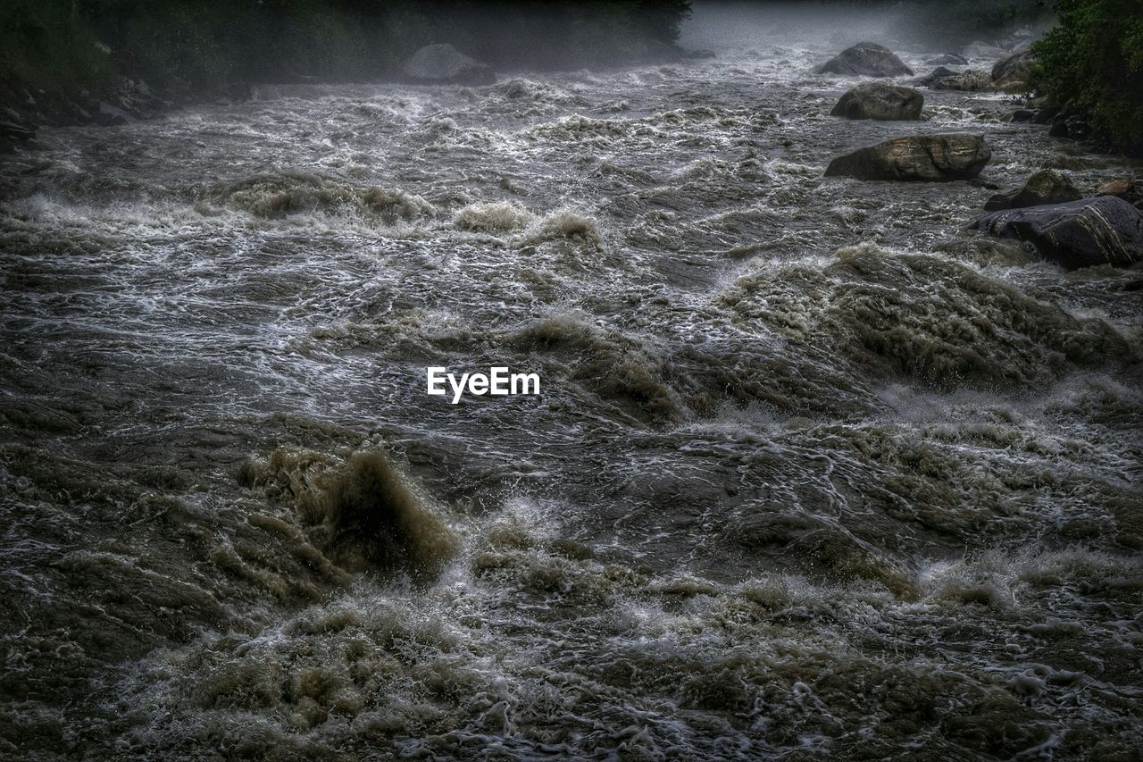 High angle view of water flowing at river