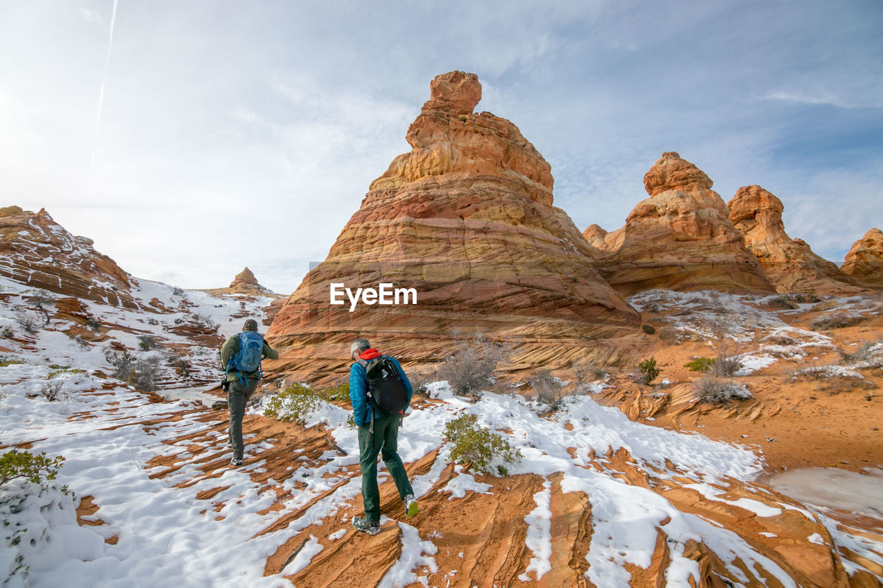 Hikers headed towards snowy cottonwood cove in the south coyote buttes