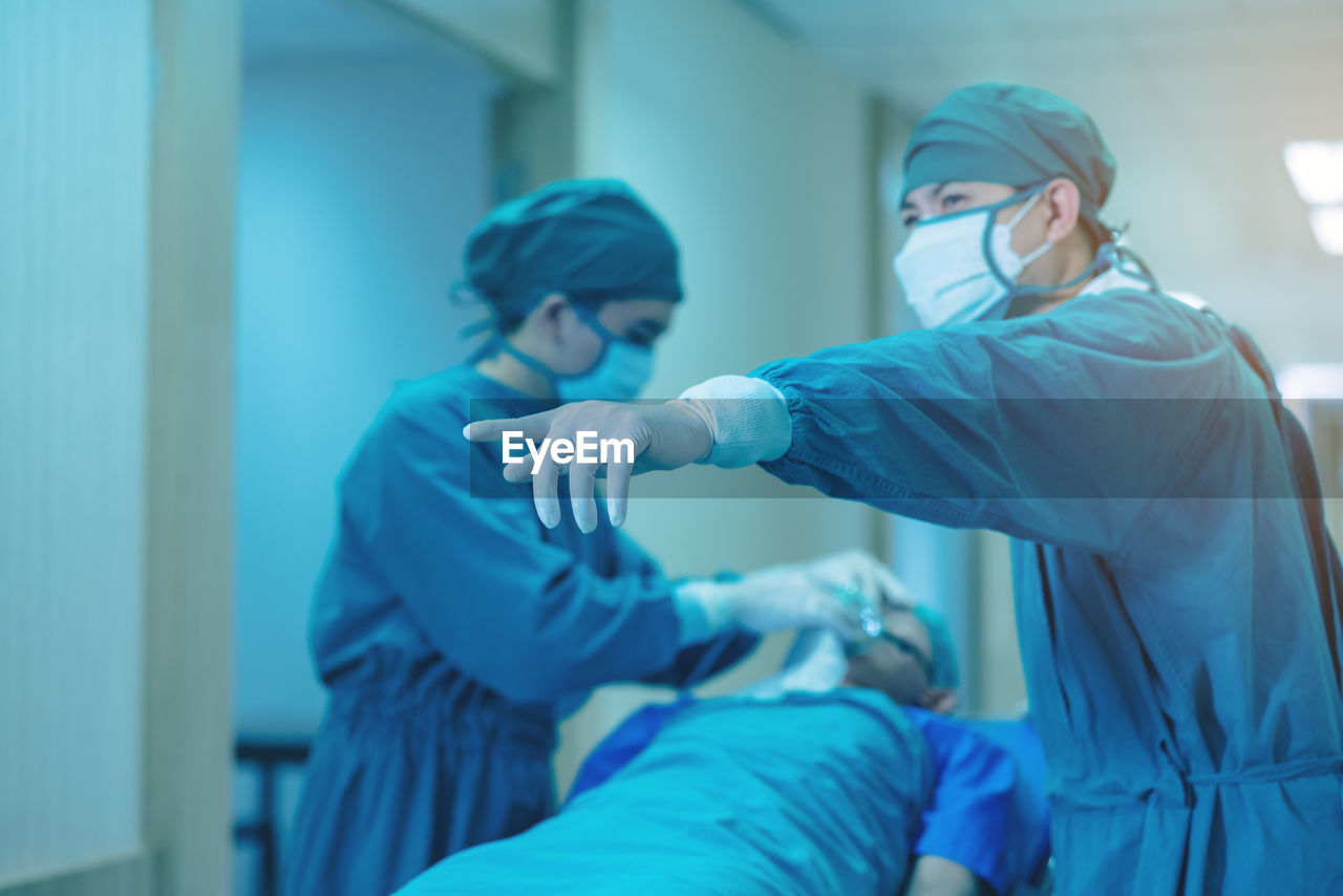 Doctor getting their patient ready for the next procedure in the corridor, a medical team