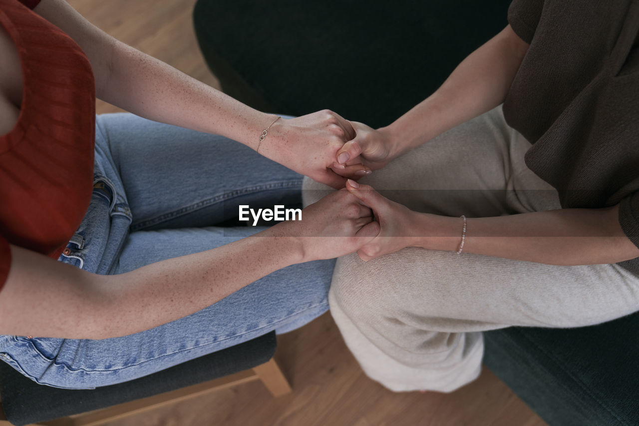 High angle view of women holding hands