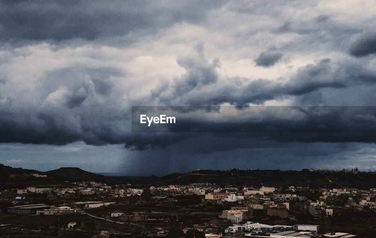 CITYSCAPE AGAINST DRAMATIC SKY