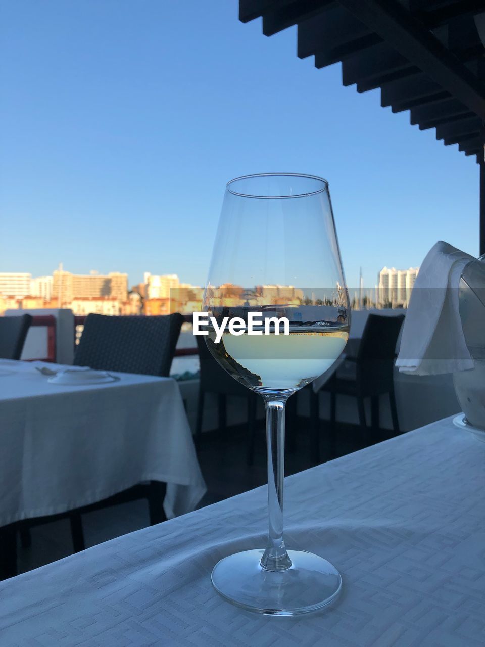 Glass of table at restaurant against clear sky