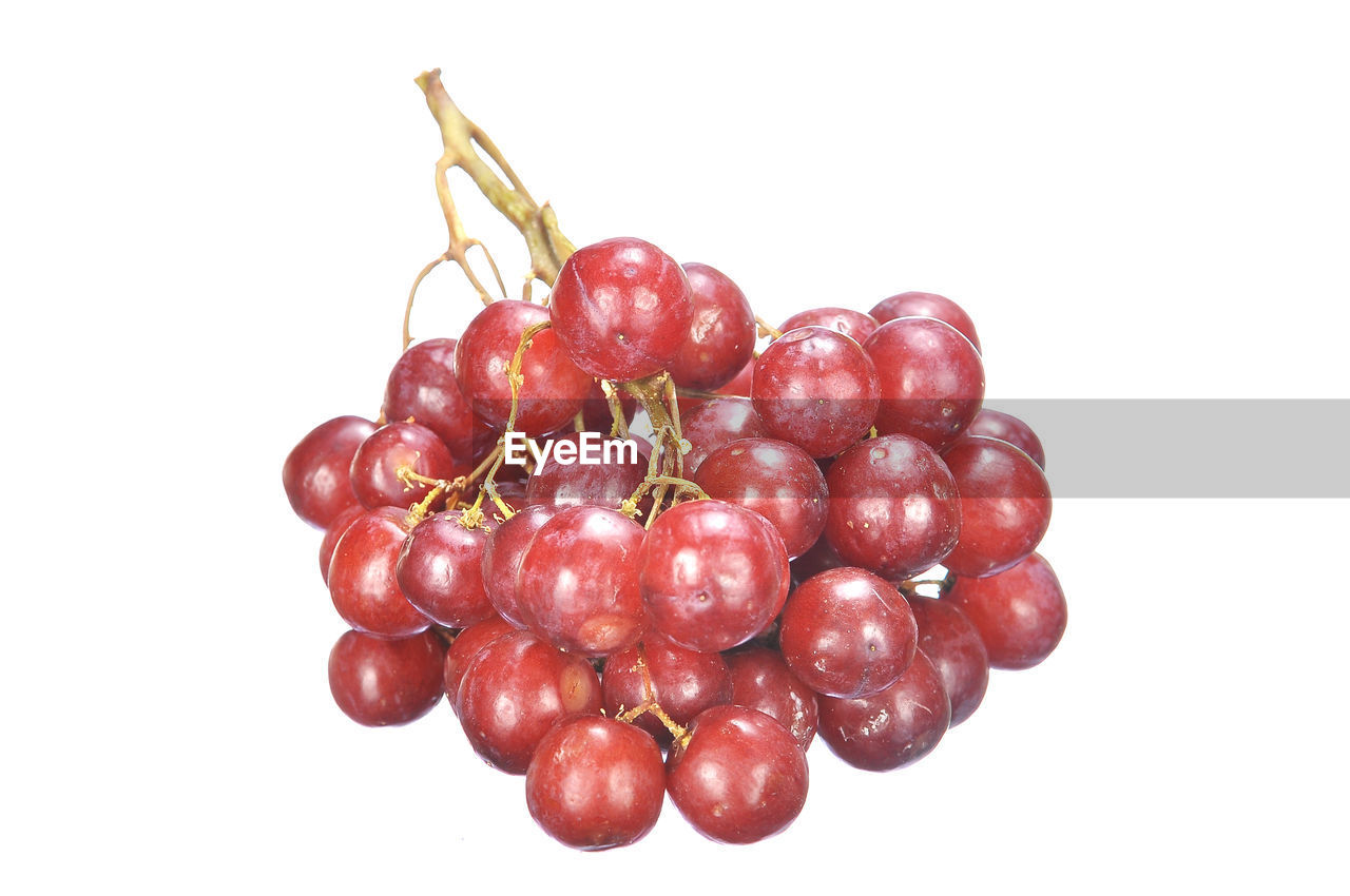Close-up of red grapes on white background