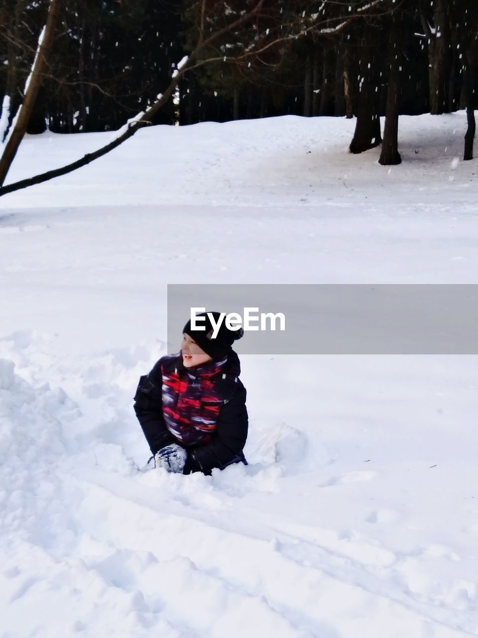 Boy on snow covered field