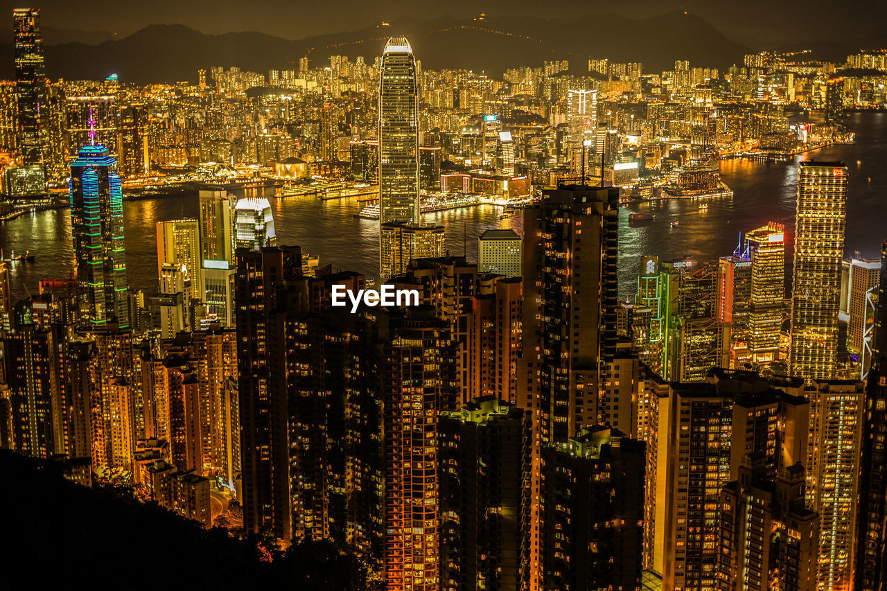 high angle view of illuminated cityscape against sky at night