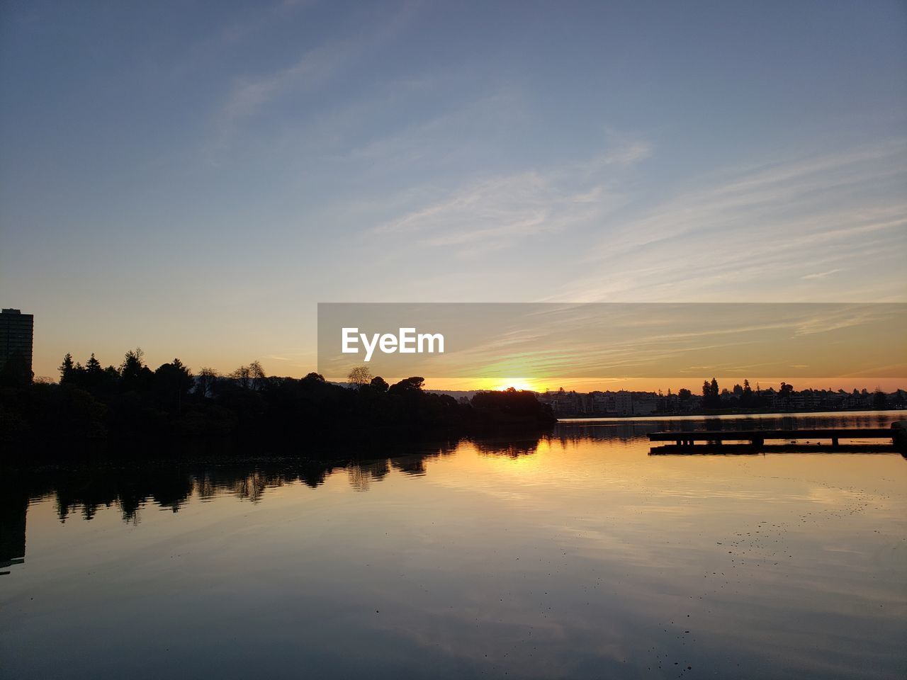 Scenic view of lake against sky during sunset