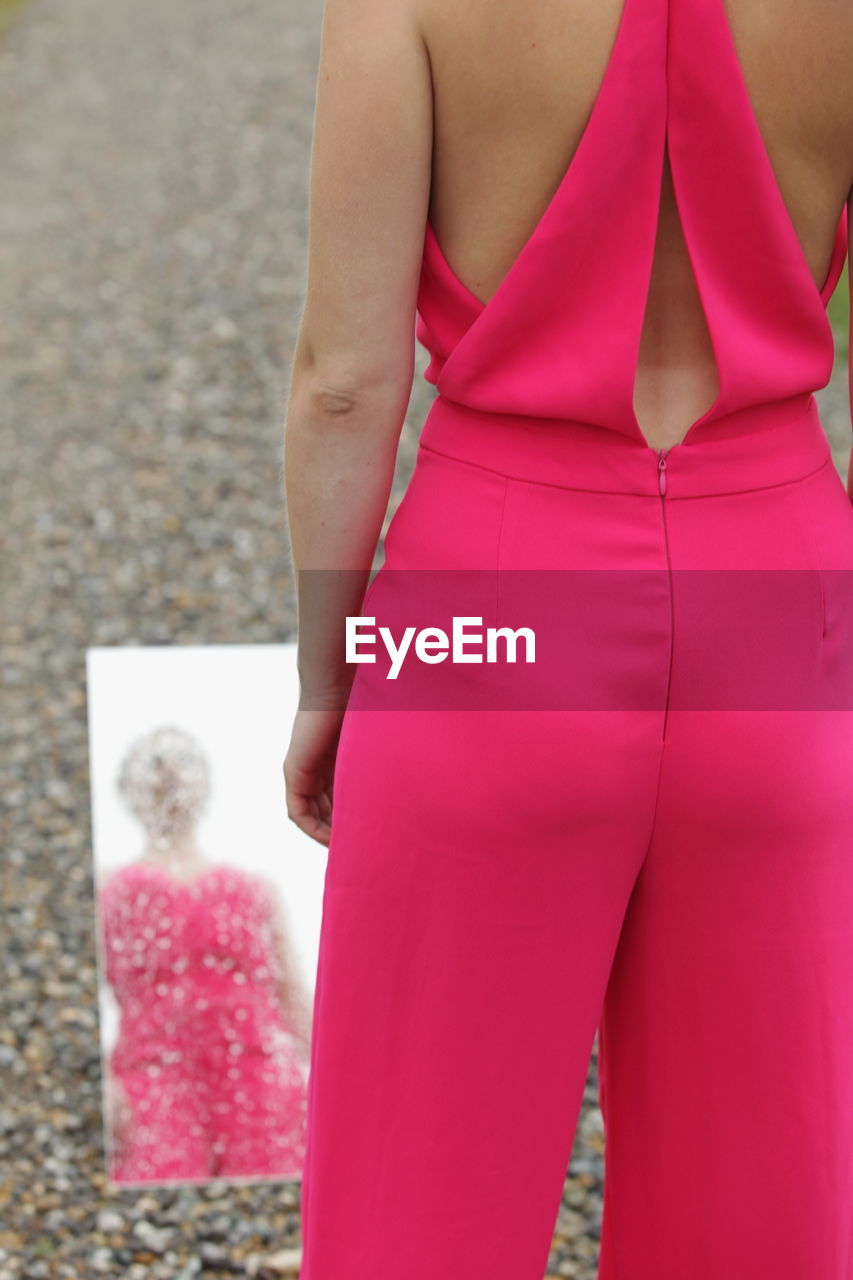 midsection of woman standing on street