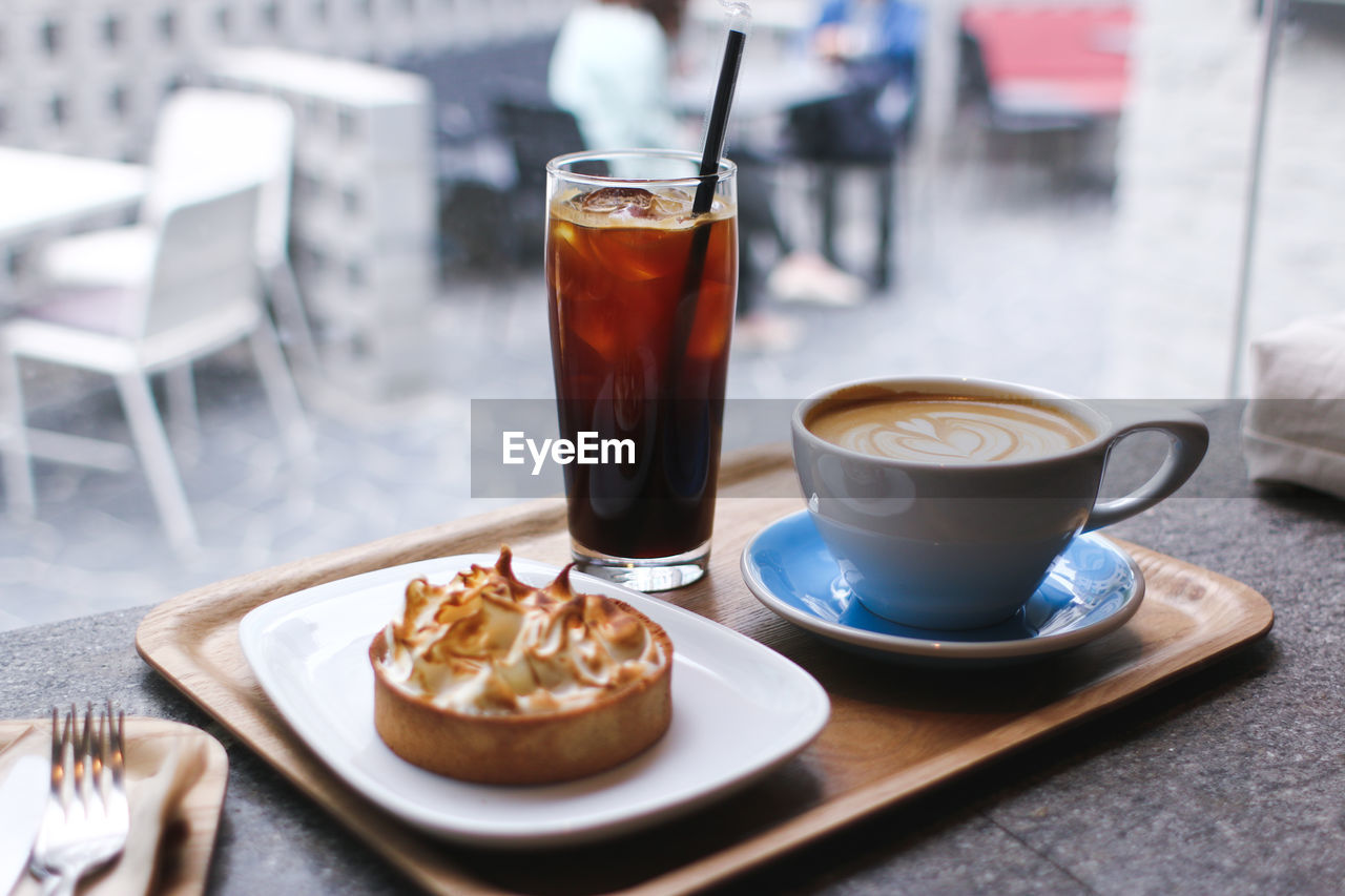 Close-up of coffee and breakfast served on table in restaurant