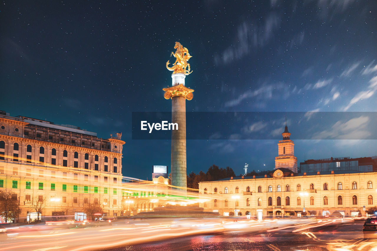 low angle view of illuminated buildings in city at night