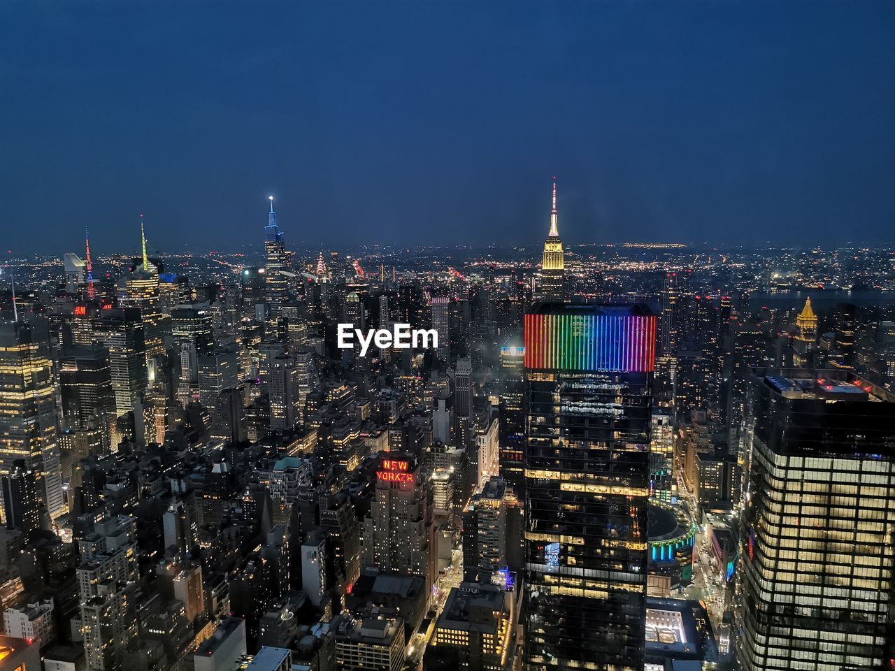 high angle view of illuminated cityscape against sky at night