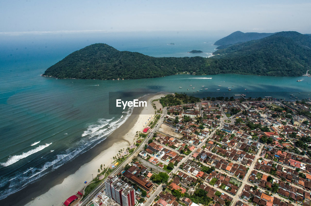 High angle view of sea and buildings against sky