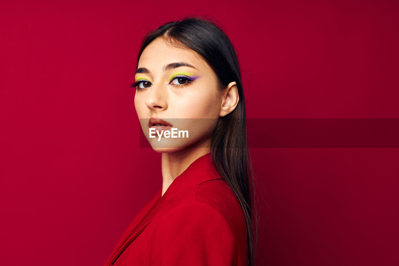 portrait of beautiful young woman against yellow background