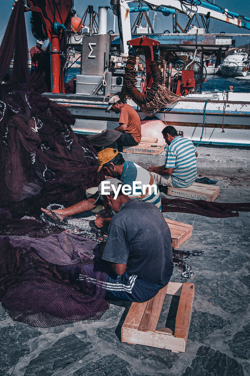 HIGH ANGLE VIEW OF PEOPLE WORKING AT DUSK