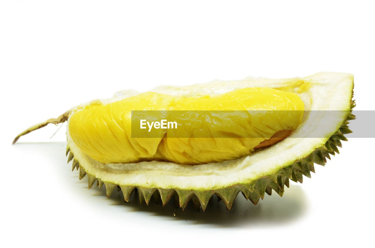 CLOSE-UP OF BANANA AGAINST WHITE BACKGROUND