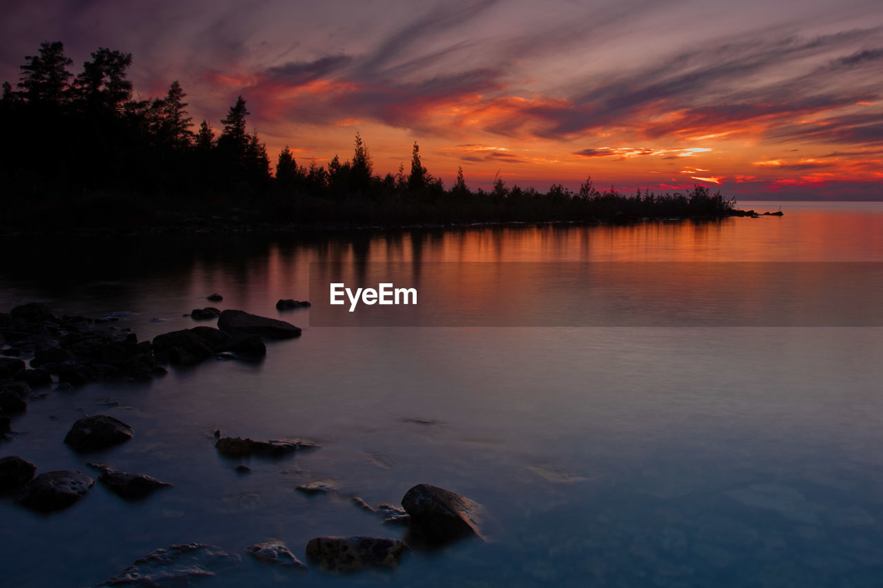 Scenic view of lake at sunset