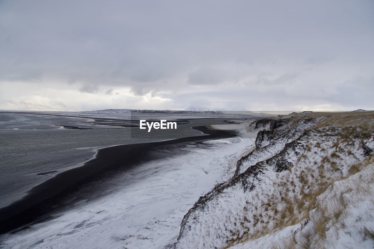 Scenic view of sea against sky during winter