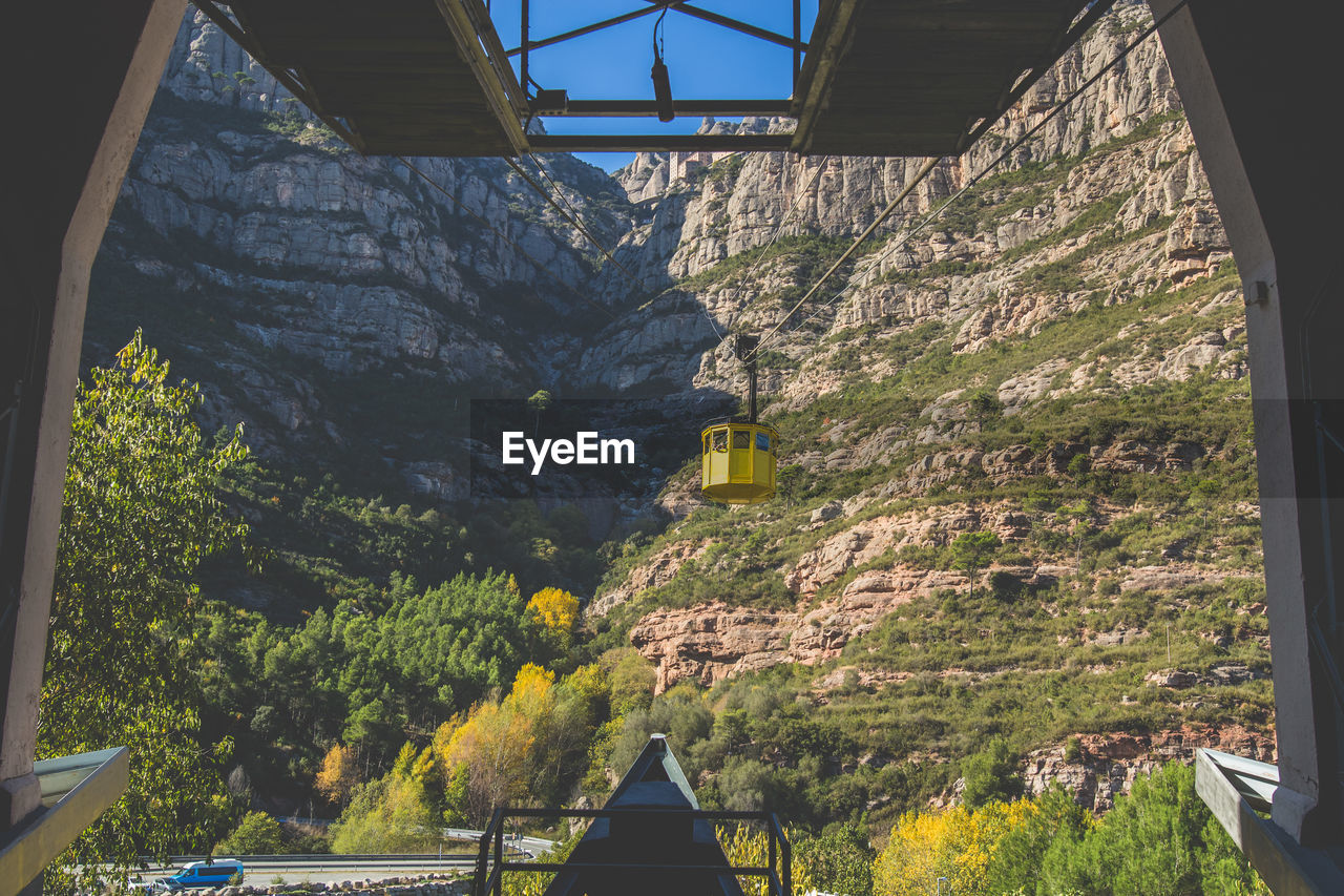 Overhead cable car against mountain