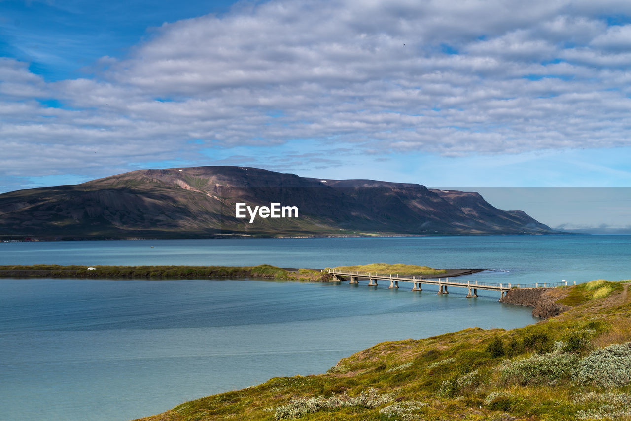 Scenic view of lake and mountains against sky