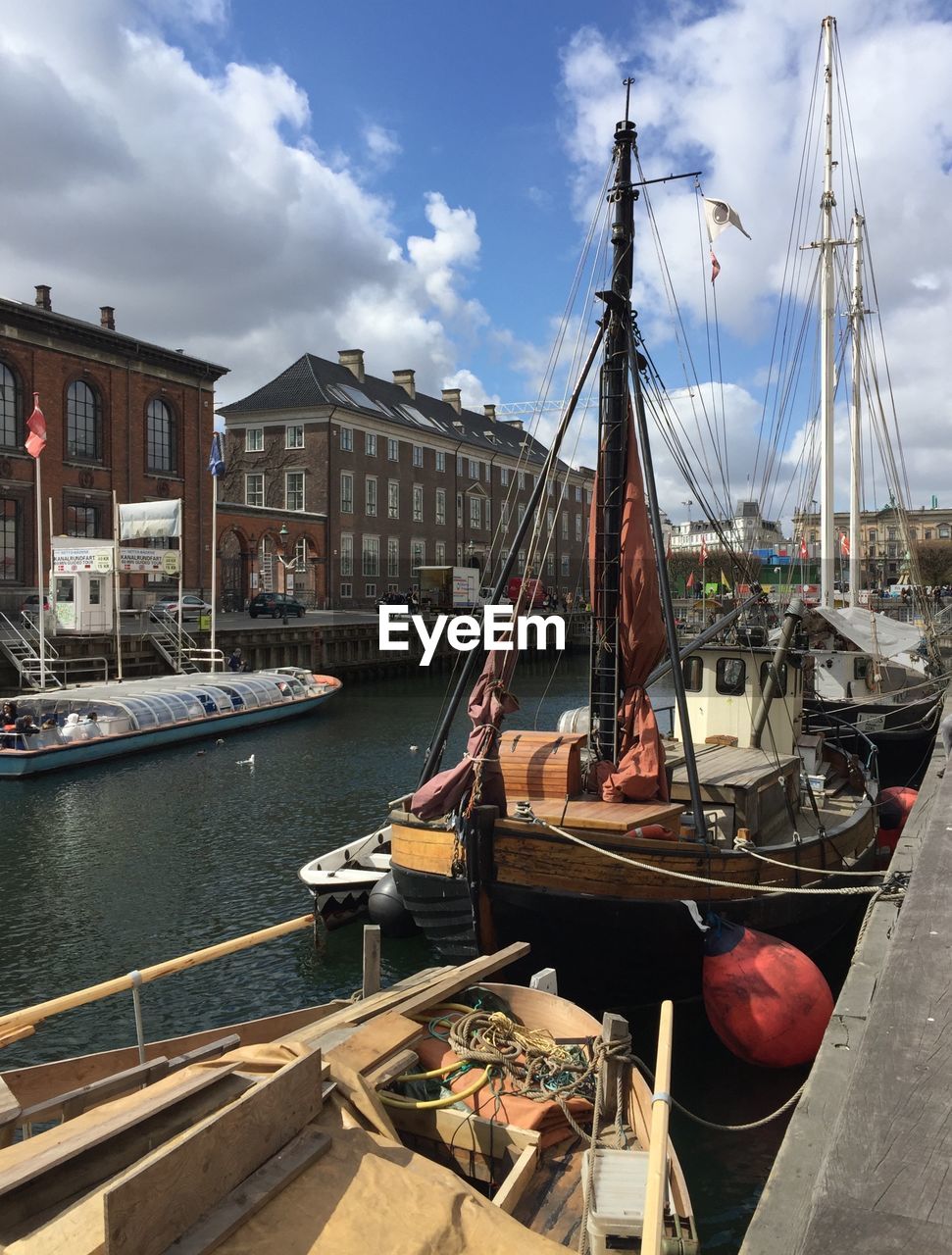 SAILBOATS MOORED IN HARBOR