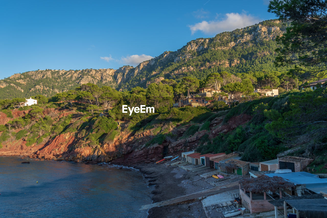 Scenic view of sea and mountains against sky