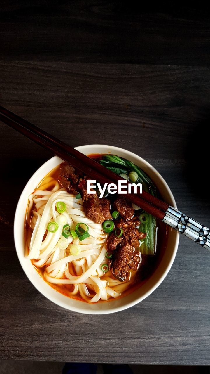 High angle view of taiwanese beef noodle soup with chopsticks 