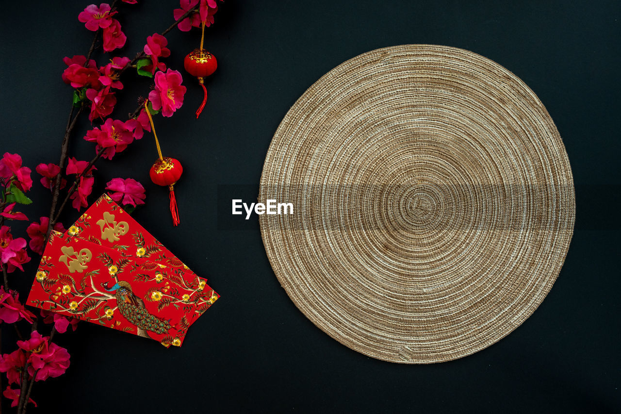 Chinese lunar new year decoration over black background. flat lay dinning table concept.