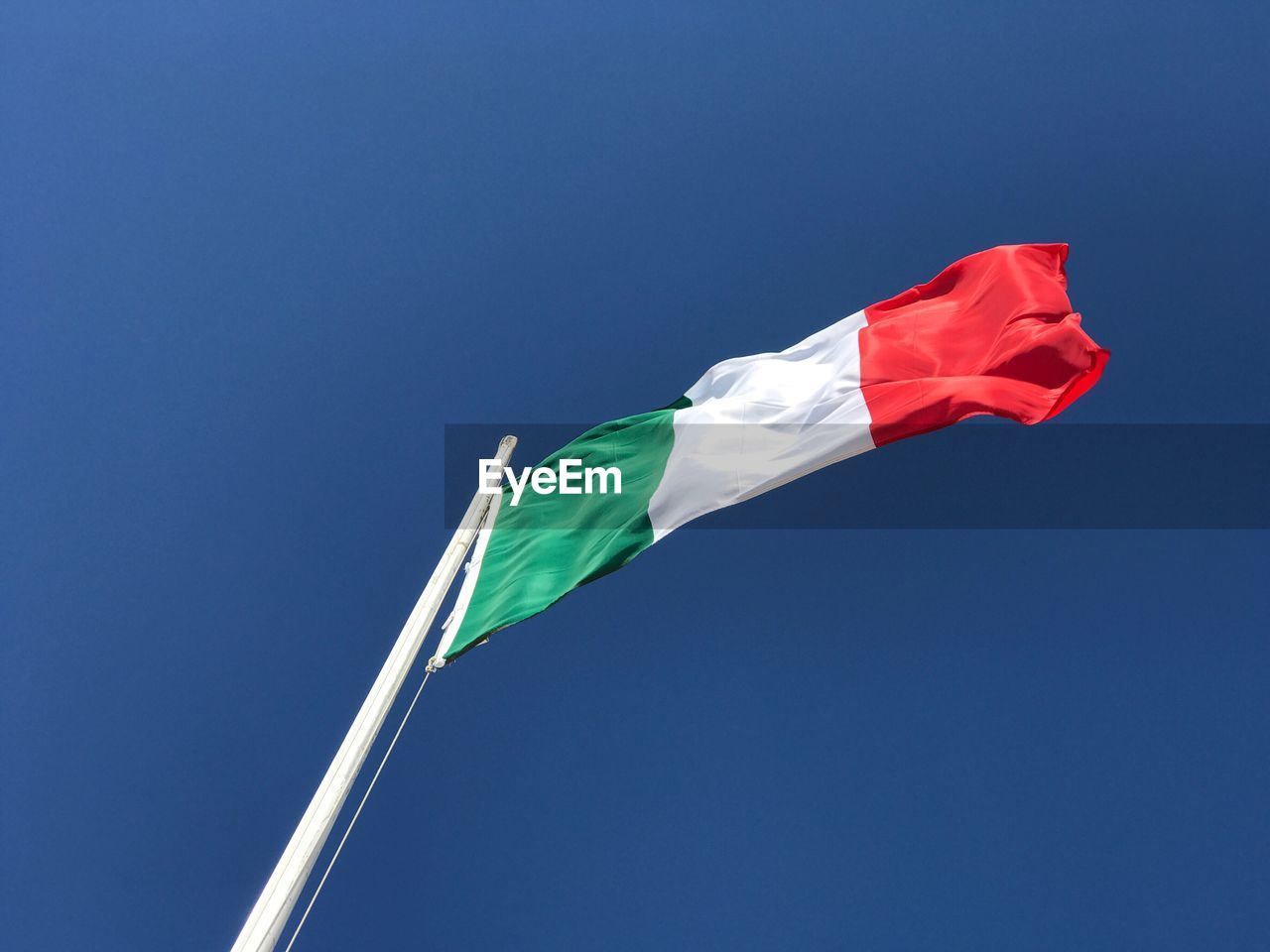 LOW ANGLE VIEW OF FLAG FLAGS AGAINST CLEAR BLUE SKY