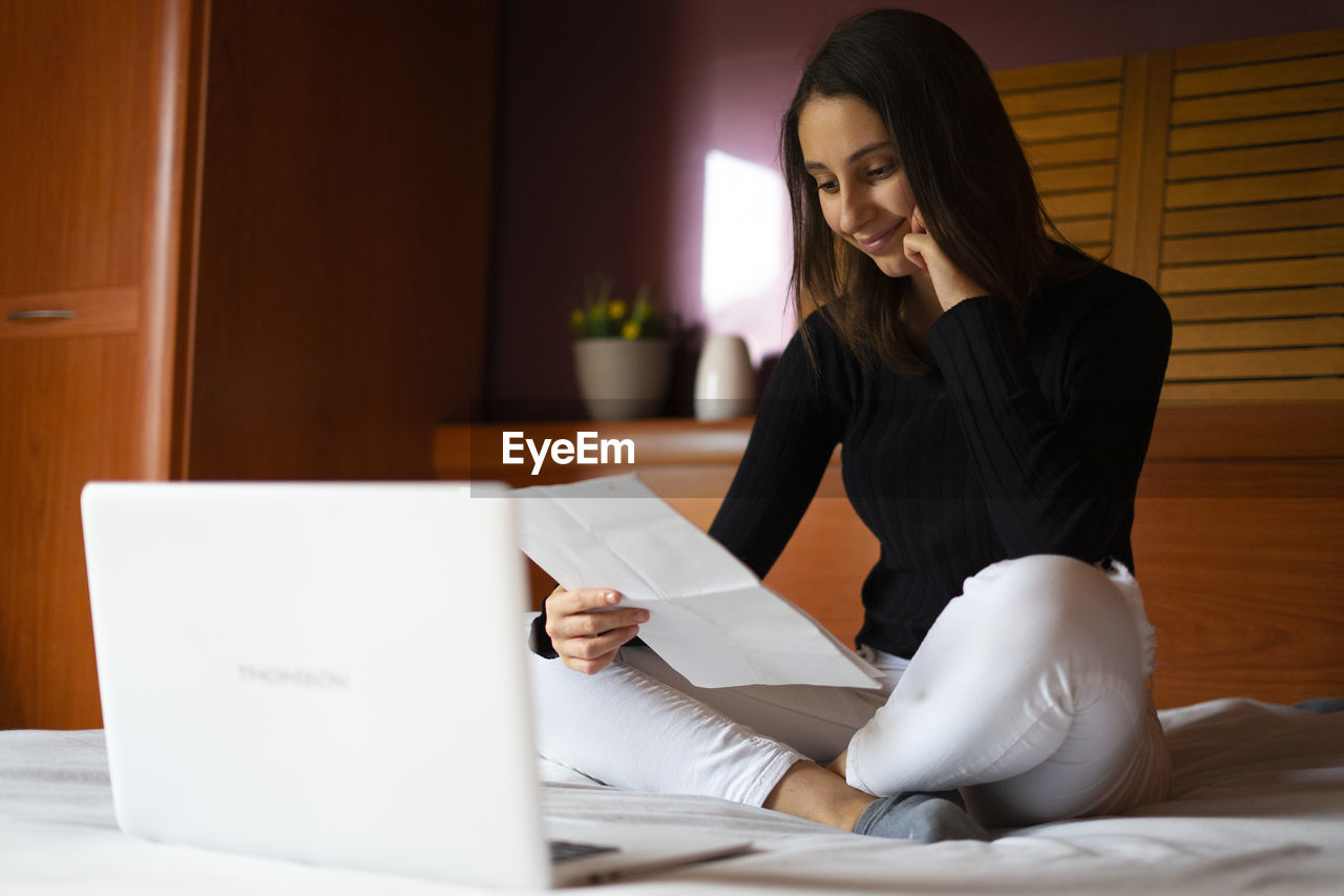 Woman doing her resume on the computer.