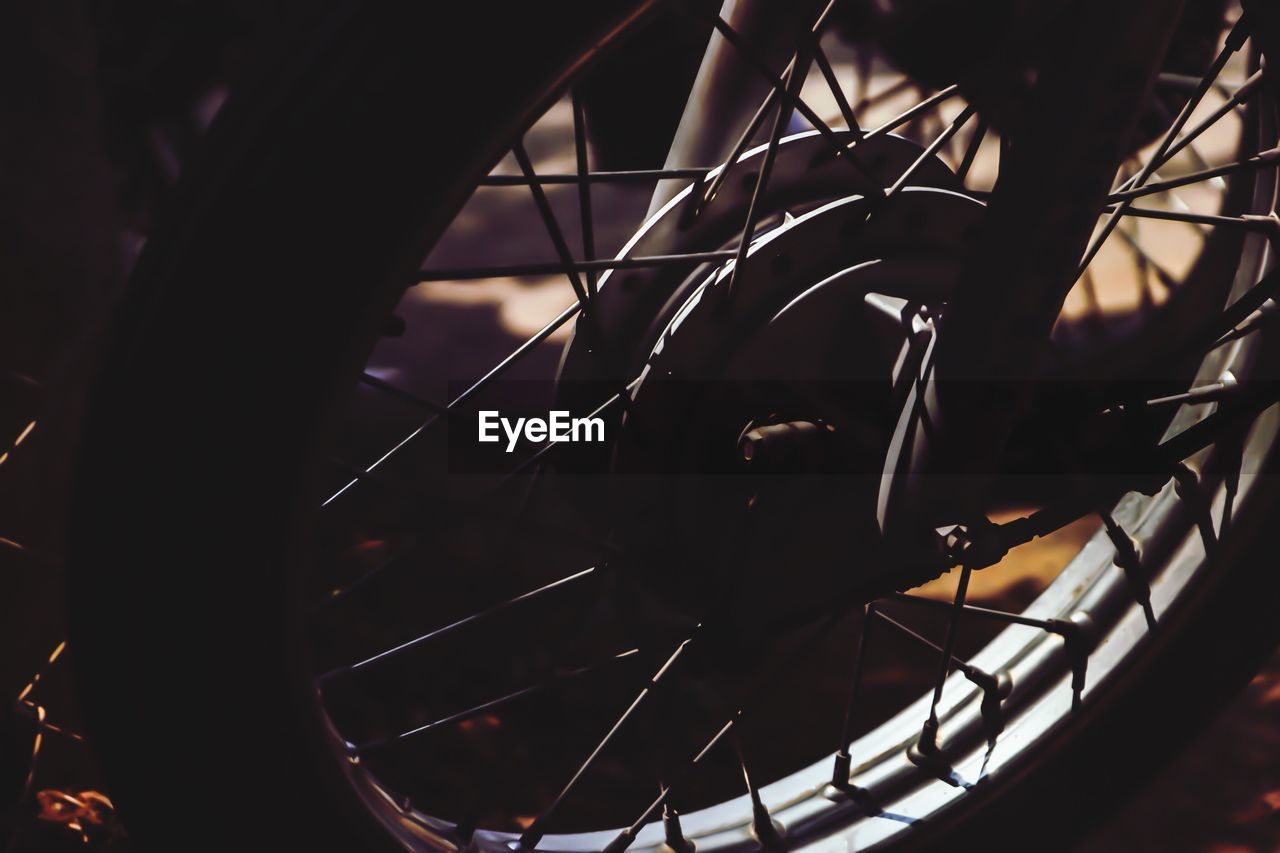 Close-up of cropped motorcycle wheel on field