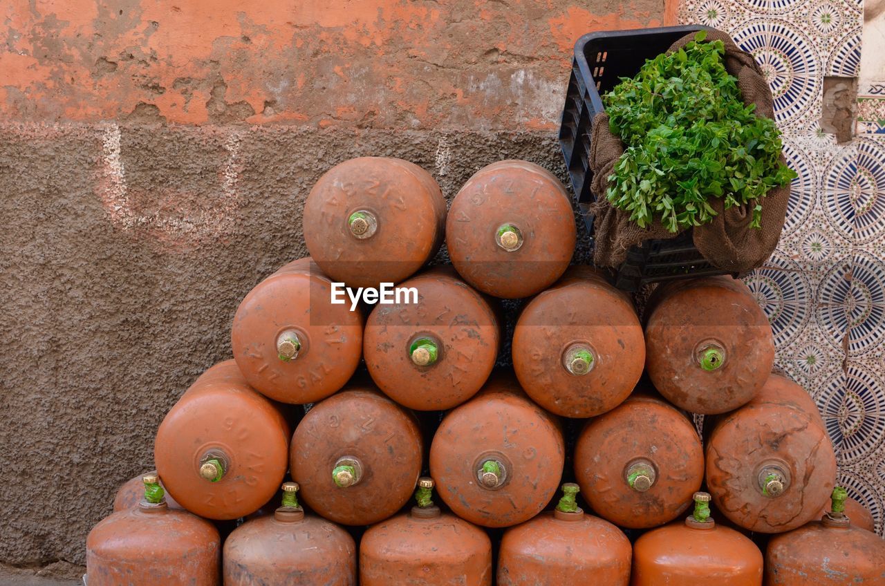 High angle view of gas cylinder by vegetables on sidewalk