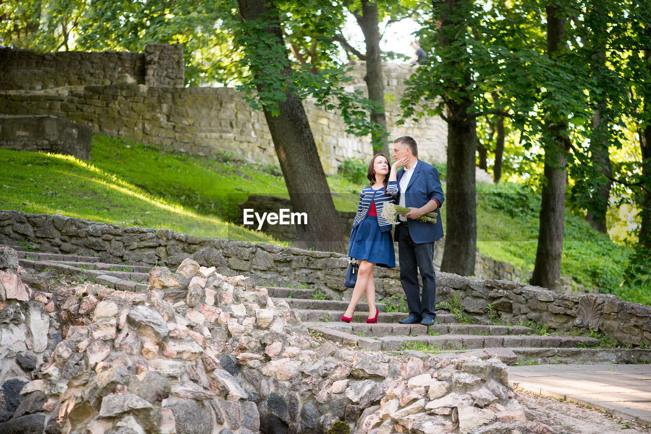 Couple standing on steps at public park