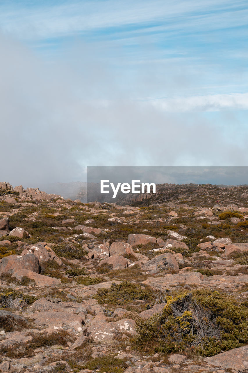 SCENIC VIEW OF LANDSCAPE AND MOUNTAINS AGAINST SKY