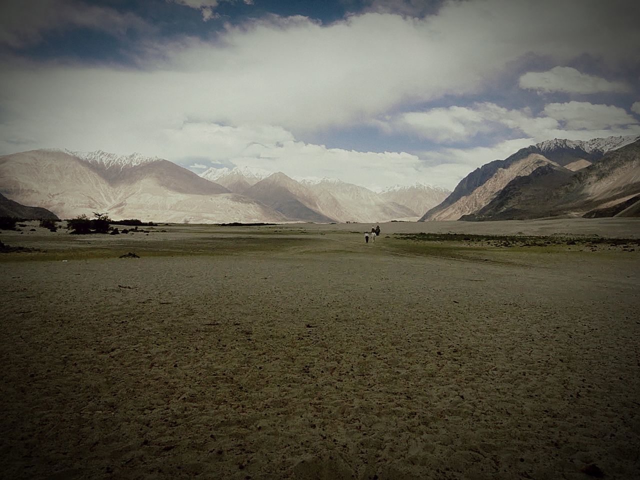 SCENIC VIEW OF MOUNTAINS AGAINST CLOUDY SKY