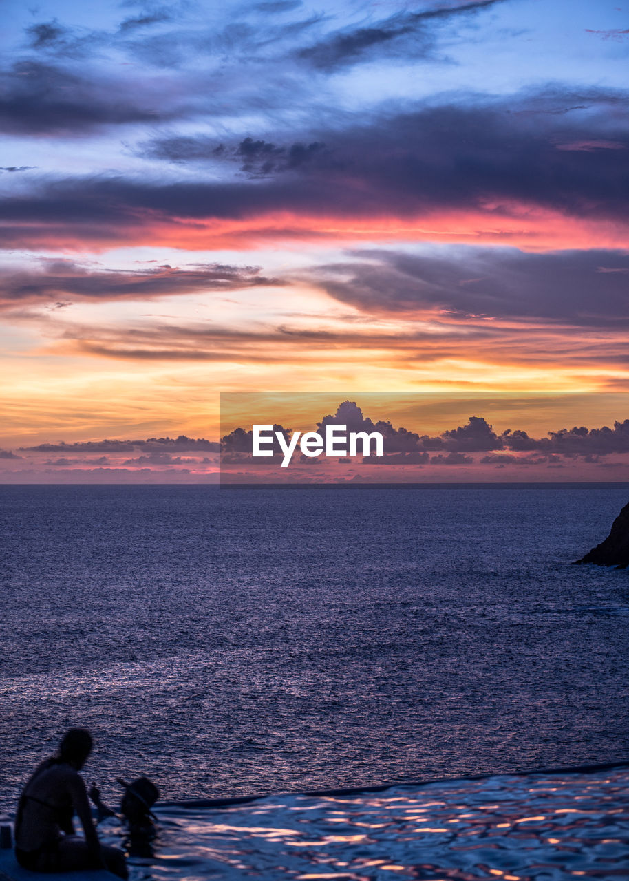 SCENIC VIEW OF SEA AGAINST ORANGE SKY DURING SUNSET